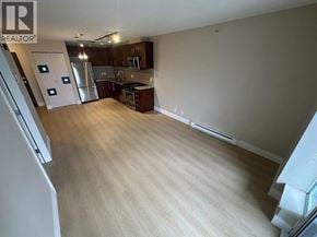 Richmond apartment for rent - A spacious living room with a kitchen area in the background.