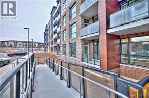 Stoney Creek condo for rent - A balcony of a building with a railing and a REALTOR® logo.