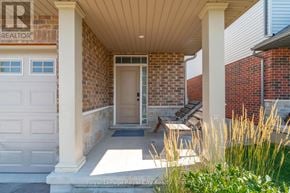 Guelph (Grange Road) townhouse for rent - A white door is on the brick wall of a house.