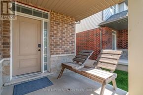 Guelph (Grange Road) townhouse for rent - A wooden bench is placed on a concrete porch.