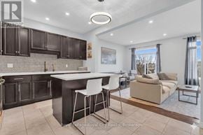 Guelph (Grange Road) townhouse for rent - A modern kitchen with dark brown cabinets and a white island.