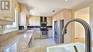 Toronto (Morningside) apartment for rent - A kitchen with granite countertops and stainless steel appliances.
