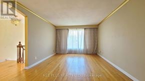 Toronto (Morningside) apartment for rent - A room with wooden flooring and a window with curtains.