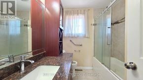 Toronto (Morningside) apartment for rent - A bathroom with a sink, mirror, and shower.