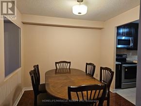 Mississauga (Cooksville) condo for rent - A dining room with a wooden table and chairs.