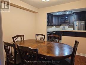 Mississauga (Cooksville) condo for rent - A dining room with a wooden table and chairs.