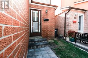 Mississauga (Creditview) apartment for rent - A brick house with a door and a small garden.