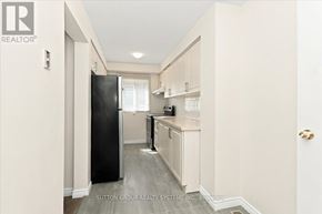 Mississauga (Creditview) apartment for rent - A kitchen with a black fridge and white cabinets.