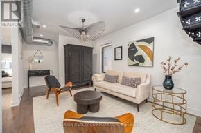 Toronto (Oakwood Village) multi-family for rent - A living room with a white couch, a wooden coffee table, and a black cabinet.