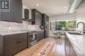Toronto (Oakwood Village) multi-family for rent - A modern kitchen with a marble countertop and stainless steel appliances.