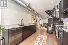 Toronto (Oakwood Village) multi-family for rent - A modern kitchen with a sink and a refrigerator.