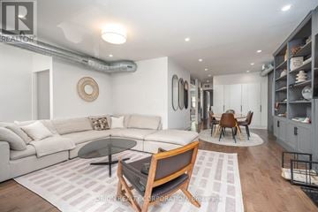 Toronto (Oakwood Village) multi-family for rent - A modern living room with a glass table and a white sofa.