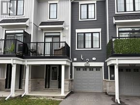 Ottawa townhouse for rent - A building with the sign REMAX HALLMARK REALTY GROUP. BROKERAGE.