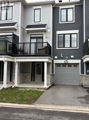 Ottawa townhouse for rent - A modern two-story residential building with a balcony on the first floor.
