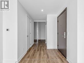 Hamilton (Beasley) condo for rent - A long hallway with a door on the right and a mirror on the wall.
