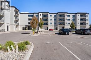 Windsor condo for rent - A parking lot in front of a building with the word REALTOR on it.