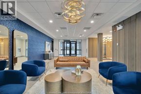 Windsor condo for rent - A modern office space with blue chairs and a wooden sofa.