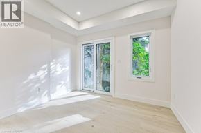 Kitchener apartment for rent - A room with a window and a door leading outside.