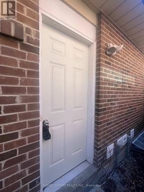 Markham (Aileen-Willowbrook) apartment for rent - A white door with a black handle is set in a brick wall.