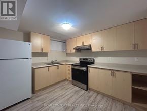 Markham (Aileen-Willowbrook) apartment for rent - A kitchen with wooden cabinets and a white fridge.
