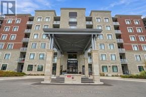 Milton (Wi Willmott) condo for rent - A large, multi-story building with a covered walkway entrance.