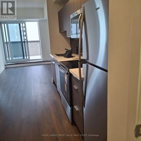 Toronto (Glenfield-Jane Heights) condo for rent - A kitchen with a refrigerator, oven, and microwave.