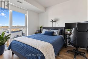 Oakville (Jm Joshua Meadows) condo for rent - A bedroom with a large bed and a chair.