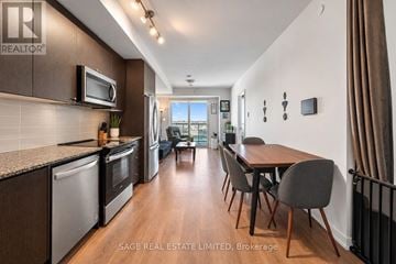 Oakville (Jm Joshua Meadows) condo for rent - A modern kitchen with a dining table and chairs.