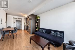 Oakville (Jm Joshua Meadows) condo for rent - A living room with a black couch and a wooden coffee table.