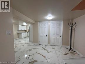 Hamilton apartment for rent - A room with marble flooring and white walls.