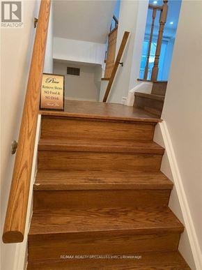 Mississauga (Churchill Meadows) townhouse for rent - A sign on a staircase requests to remove shoes and not to drink or eat.