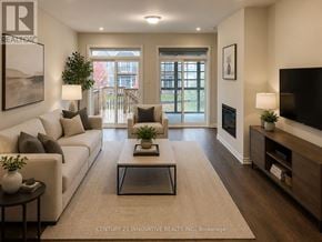 Kawartha Lakes (Bobcaygeon) townhouse for rent - A living room with a white couch, a coffee table, and a flat screen TV.