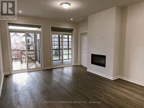 Kawartha Lakes (Bobcaygeon) townhouse for rent - A spacious room with a fireplace and sliding glass doors.