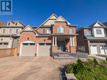 Niagara Falls (Brown) apartment for rent - A large, multi-level house with a brick facade and a garage.