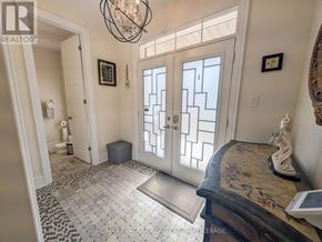 Niagara Falls (Brown) apartment for rent - A hallway with a tiled floor and a chandelier.