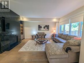 Niagara Falls (Brown) apartment for rent - A living room with a fireplace and a couch.