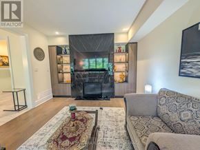 Niagara Falls (Brown) apartment for rent - A living room with a grey couch and a patterned rug.
