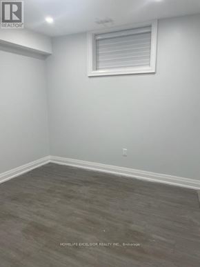 Toronto (Birchcliffe-Cliffside) apartment for rent - A room with a window and wooden flooring.