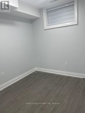 Toronto (Birchcliffe-Cliffside) apartment for rent - A room with a window and wooden flooring.