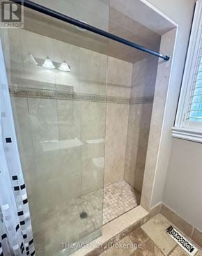 Richmond Hill (Langstaff) apartment for rent - A shower area with a glass door and a tiled floor.