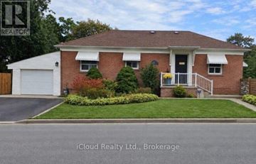 Toronto (Humber Heights) apartment for rent - A house with a red brick exterior and a white garage door.