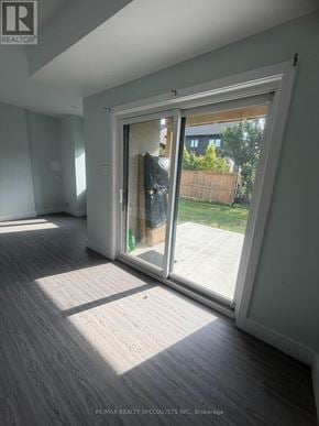 Guelph (Clairfields/Hanlon Business Park) apartment for rent - A room with a sliding glass door leading to a backyard.