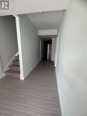 Guelph (Clairfields/Hanlon Business Park) apartment for rent - A hallway with a staircase on the left and a door on the right.