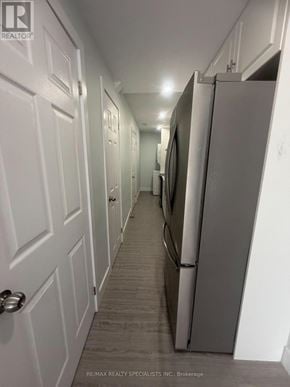 Guelph (Clairfields/Hanlon Business Park) apartment for rent - A hallway with white doors and a Re/Max Realty sign.