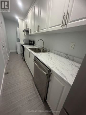 Guelph (Clairfields/Hanlon Business Park) apartment for rent - A kitchen with white cabinets and a marble countertop.