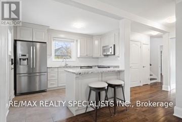 Hamilton (Sunninghill) apartment for rent - A kitchen with white cabinets and a refrigerator.