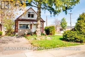 Hamilton (Sunninghill) apartment for rent - A house with a tree in front of it and the text RE/MAX REALTY SPECIALISTS INC. Brokerage.