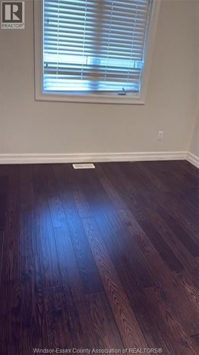 Lakeshore apartment for rent - A room with a window and wooden flooring.