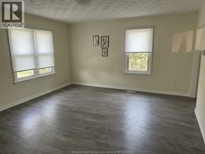 Lakeshore apartment for rent - A room with wooden flooring and two windows.