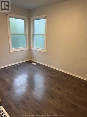 Lakeshore apartment for rent - A room with wood flooring and two windows.